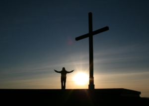 Worship with cross in sunset