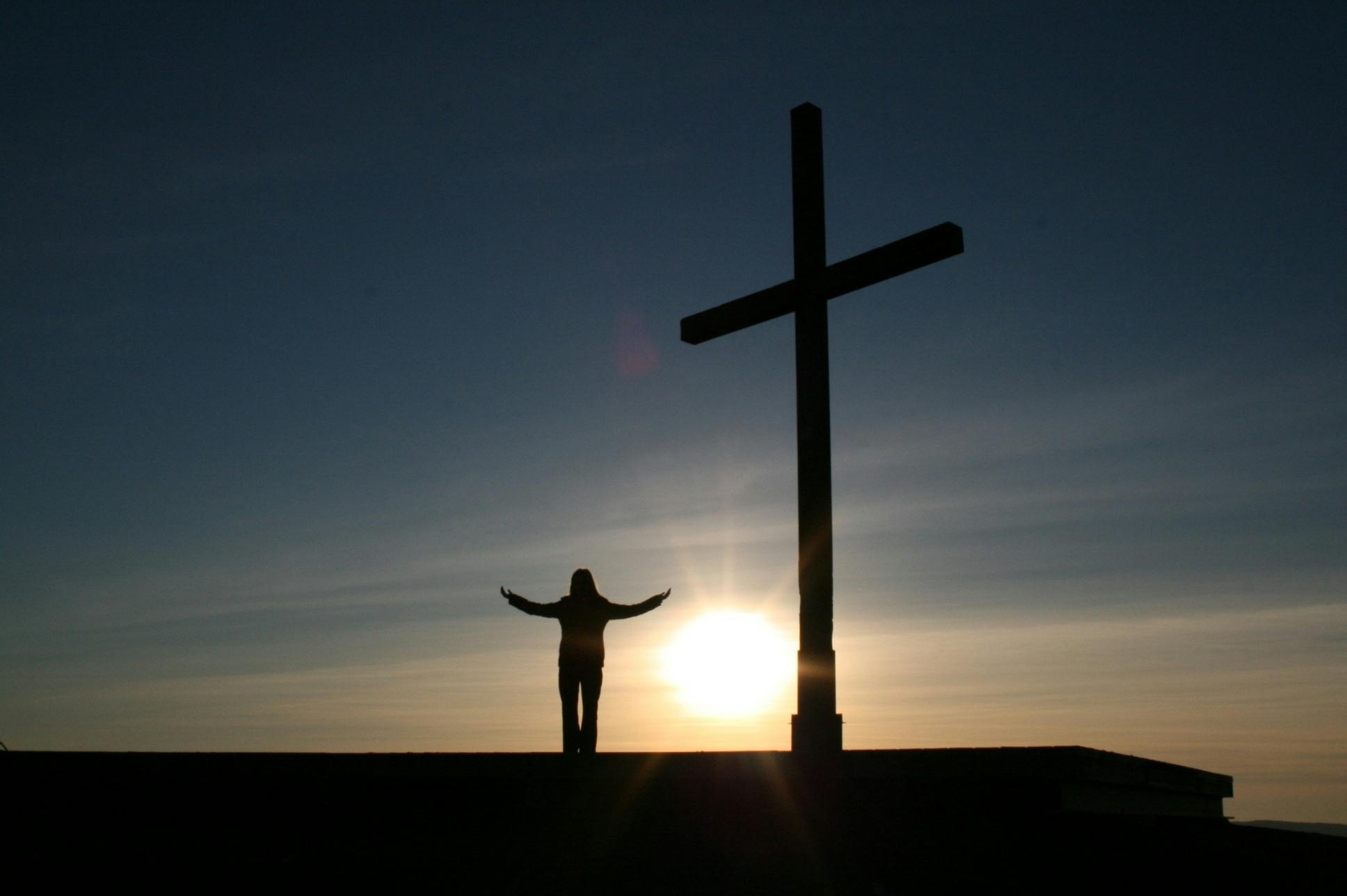 Worship with cross in sunset