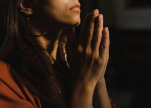 A woman prays to God