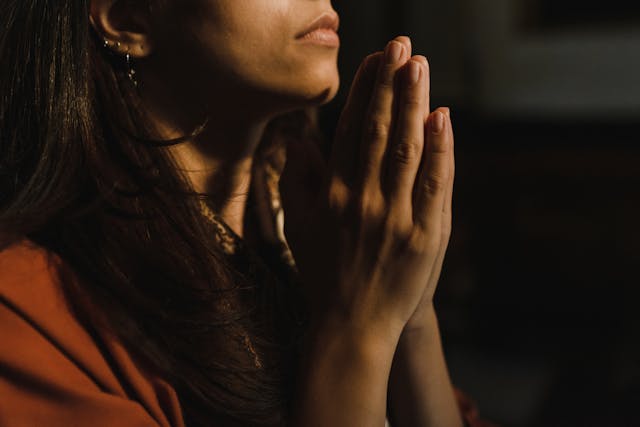 A woman prays to God