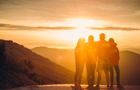 People Standing on the top of a Mountain during Sunset